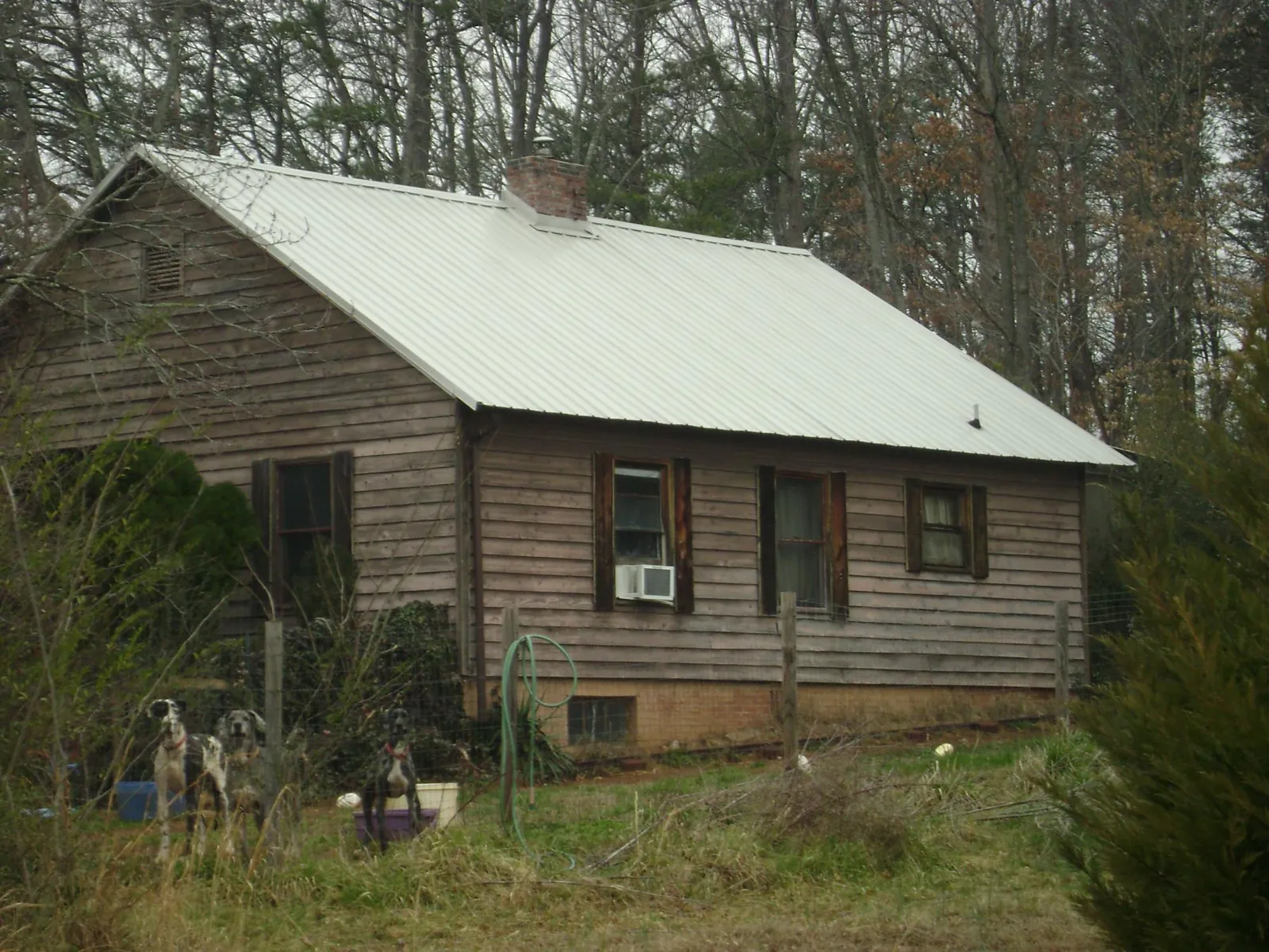 White metal roof on an old wood sided farmhouse, from a Metal Roof Installation job in Randleman